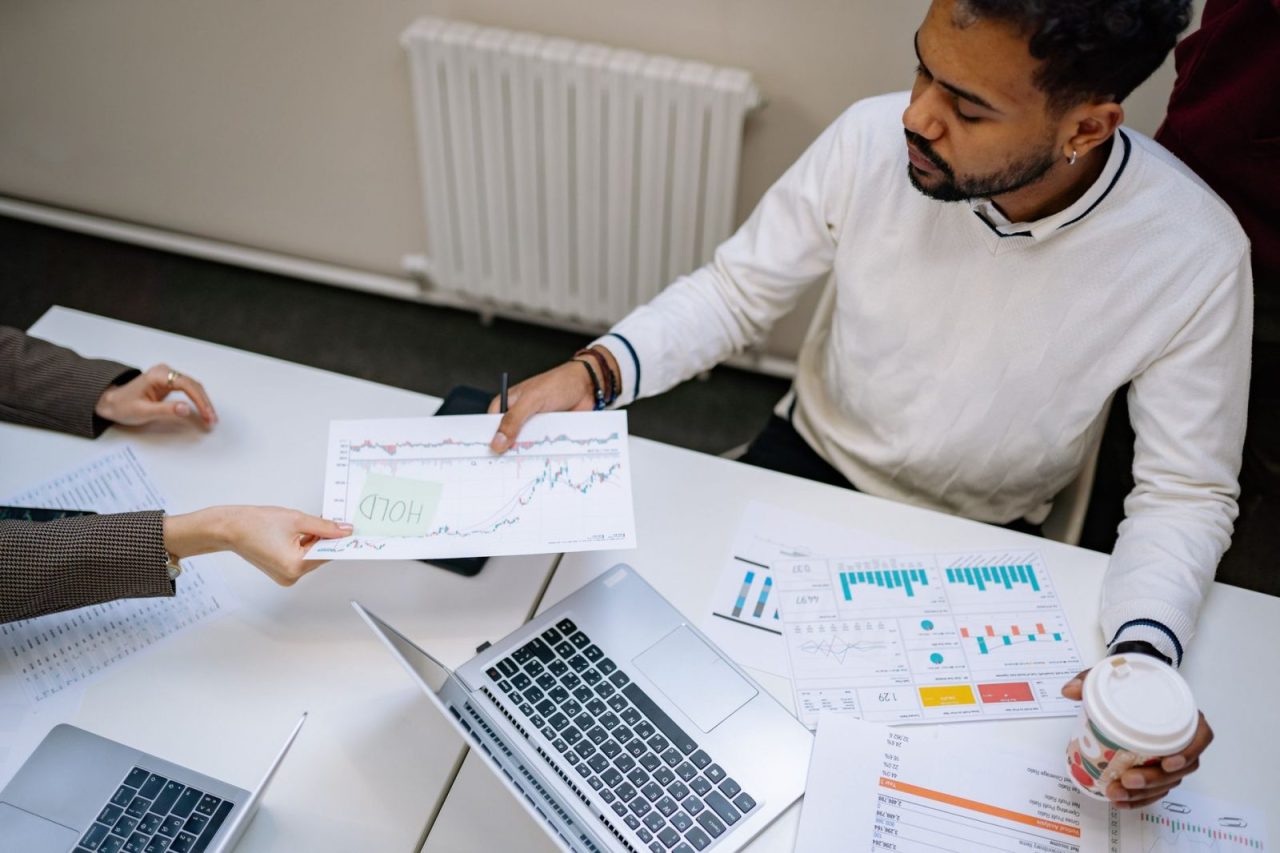 Colleagues working together on financial charts and data during a meeting