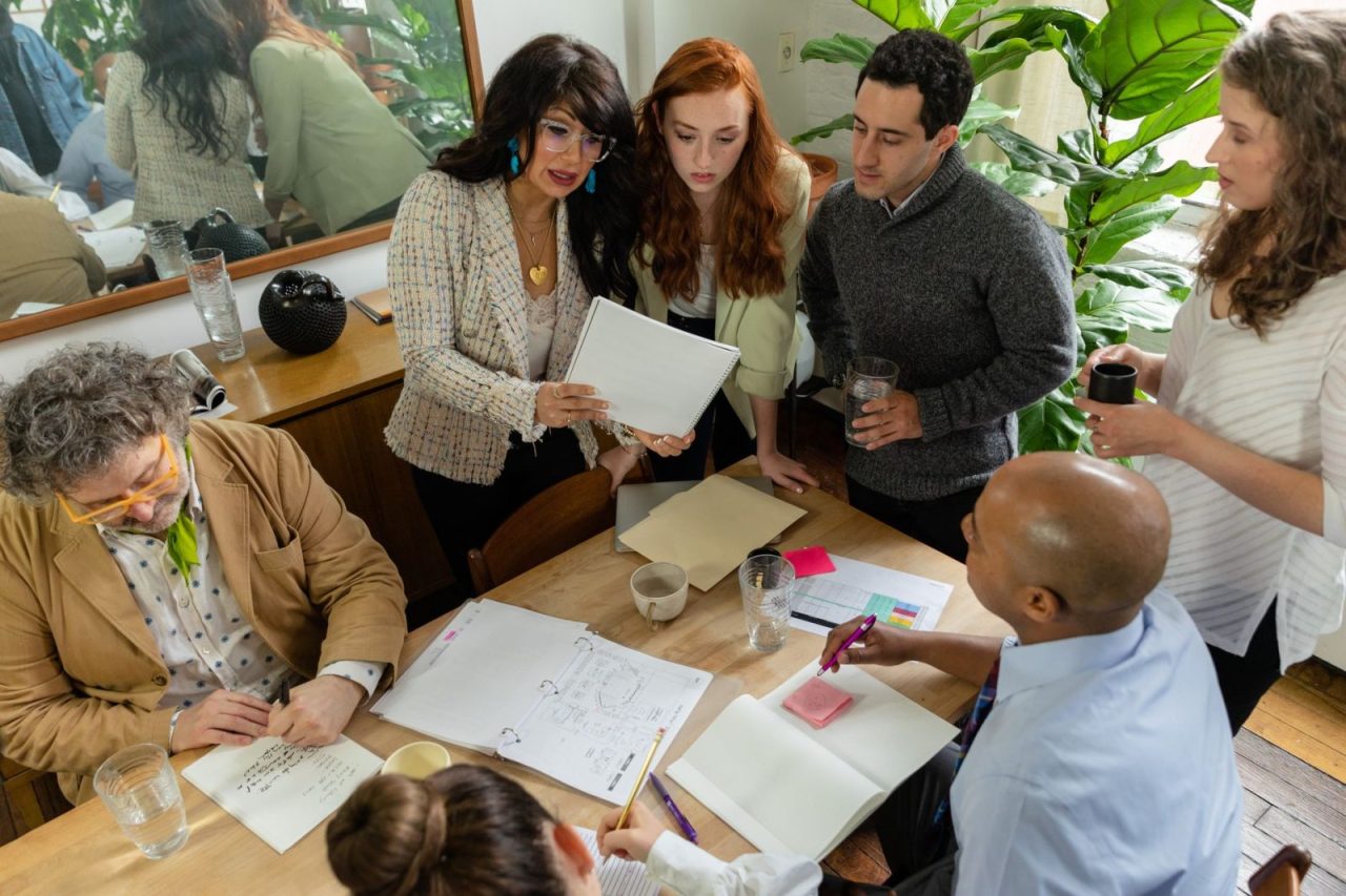 Team reviewing documents together at a table in a modern office