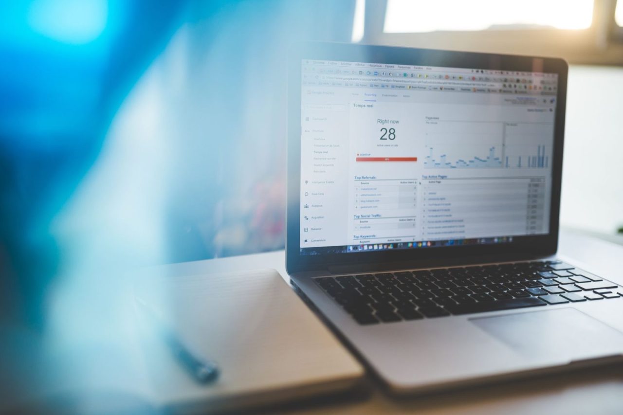 Google Analytics dashboard open on a laptop in a workspace