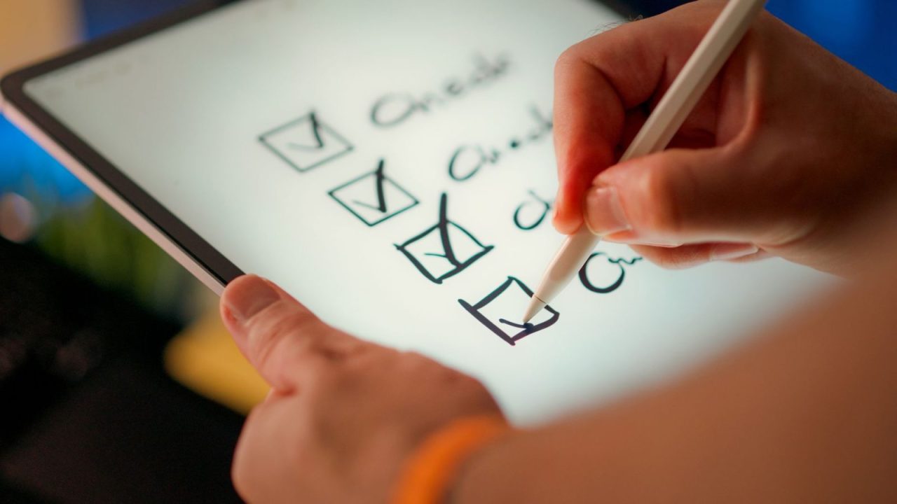 Digital checklist being marked on a tablet with a stylus pen