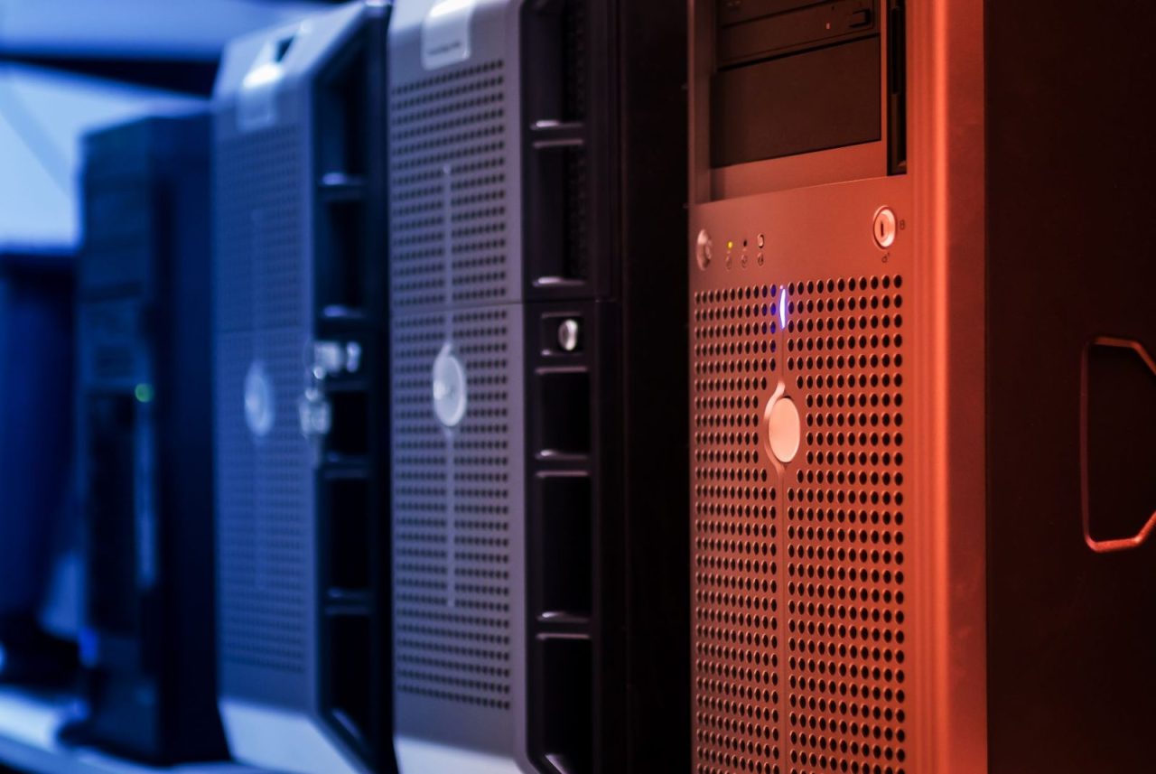 Tower servers in a data center illuminated by blue and red lighting